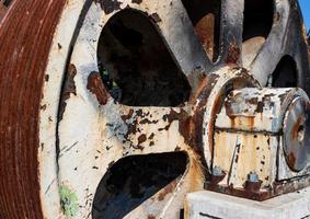 Rusty weathered steel cable spool winch photo