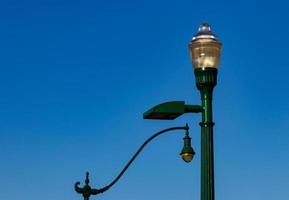 Old fashioned retro street lamps against a blue sky photo