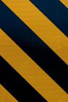 Yellow and black warning sign stripes background photo