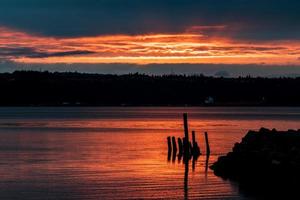 Golden sunrise sunset in a harbor with a cargo ship photo