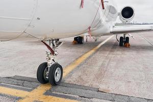 Close up view. Turboprop aircraft parked on the runway at daytime photo