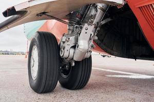 Close up view of wheels. Turboprop aircraft parked on the runway at daytime photo