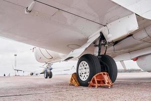 View from below. Turboprop aircraft parked on the runway at daytime photo