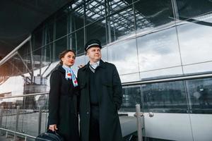 Man with woman. Aircraft crew in work uniform is together outdoors in the airport photo