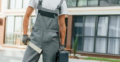 Ready for work. Young man in uniform at construction at daytime photo