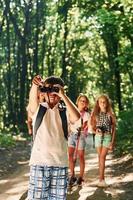 Beautiful nature. Kids strolling in the forest with travel equipment photo