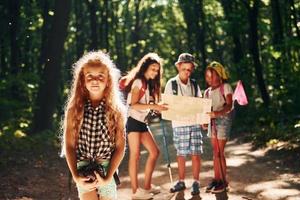 Beautiful nature. Kids strolling in the forest with travel equipment photo