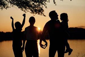 Love gesture. Family of mother, father and kids is on the camping photo