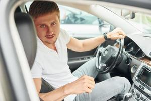 Man is sitting in modern automobile. Conception of business and success photo