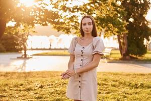 Woman standing in the autumn park. Beautiful sunshine photo