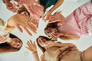 View from below. Group of happy women that is at a bachelorette party photo