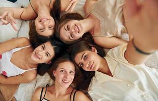 Top view of group of happy women that is at a bachelorette party photo