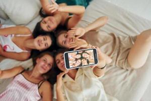 Taking selfie. Top view of group of happy women that is at a bachelorette party photo