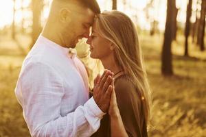 Close up view. Happy couple is outdoors in the forest at daytime photo