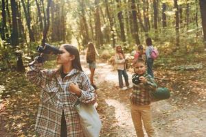 Discovering new places. Kids in green forest at summer daytime together photo