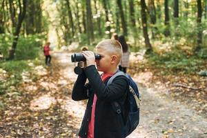 Discovering new places. Kids in green forest at summer daytime together photo