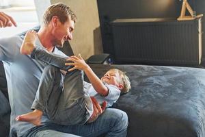 Positive emotions. Father and son is indoors at home together photo