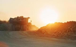 Beautiful sunshine. Loading vehicle is outdoors on the borrow pit at daytime. No people photo