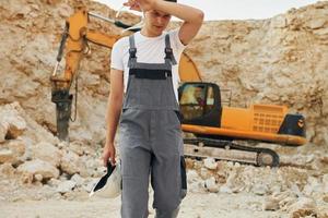 Operator is working on the borrow pit. Man in professional uniform photo