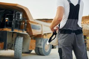 vista de cerca el trabajador con uniforme profesional está en el pozo de préstamo durante el día foto