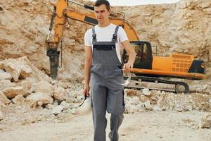 Operator is working on the borrow pit. Man in professional uniform photo