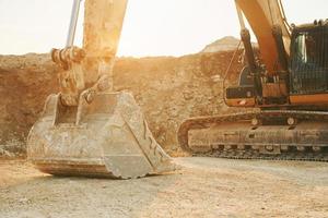 No people. Loading vehicle is outdoors on the borrow pit at daytime photo