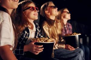 Interesting movie. Group of kids sitting in cinema photo