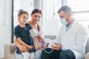 Helping kid. Two doctors in white coats is in the clinic working together photo