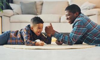 Side view. African american father with his young son at home photo