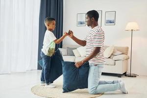 Happy family. African american father with his young son at home photo