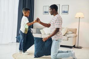 Happy family. African american father with his young son at home photo