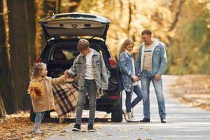 Weekend activities. Happy family is in the park at autumn time together photo