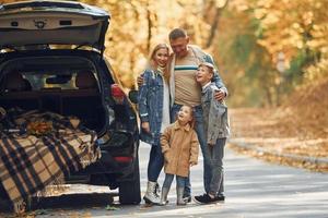 Cheerful people. Happy family is in the park at autumn time together photo