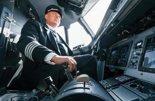 A professional pilot is in the cockpit. Conception of work photo