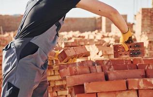 Construction worker in uniform and safety equipment have job on building photo