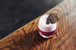 Delicious drink. Close up view of fresh summer cocktail on the wooden table photo