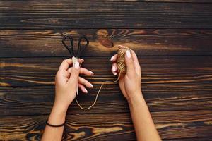 Woman's hands holds toys. Top view of christmas festive texture with new year decorations photo