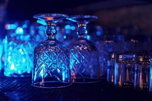 Close up view of row of empty glasses on table in the pub indoors photo