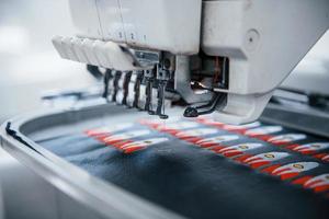 Making rocket pictures. Close up view of white automatic sewing machine at factory in action photo