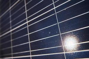 Close up view of polished surface of solar batteries at sunny daytime photo