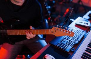 Guitar player have recording session indoors in the studio photo