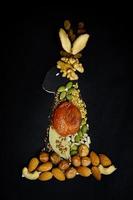 hare lined with nuts, dried fruits on a dark background photo