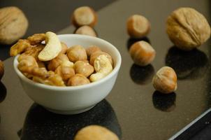 nuts in a white plate on a dark background photo