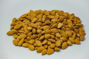 almond nut on a light background lies in a heap photo