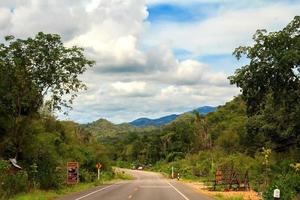 Road, steep slopes, mountains, sky, peaceful atmosphere, is a route for traveling in the countryside with beautiful nature, but the risk of traveling requires careful driving. photo