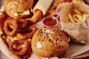 Unhealthy and junk food. Different types of fast food on the table, closeup