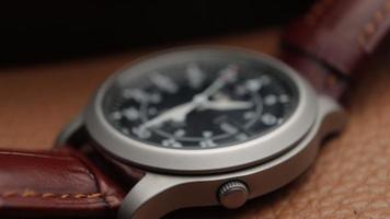 Macro close up of an automatic mechanical field watch with moving arms video