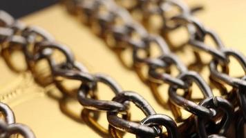 Close up of metal chain links conveying the message of power or entrapment video