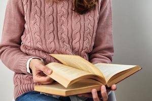 Woman sitting and reading a book. Relaxing concept photo