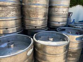 metal barrels at a construction site. large containers for liquid and bulk building materials. barrels have a black lid so as not to spill the liquid photo